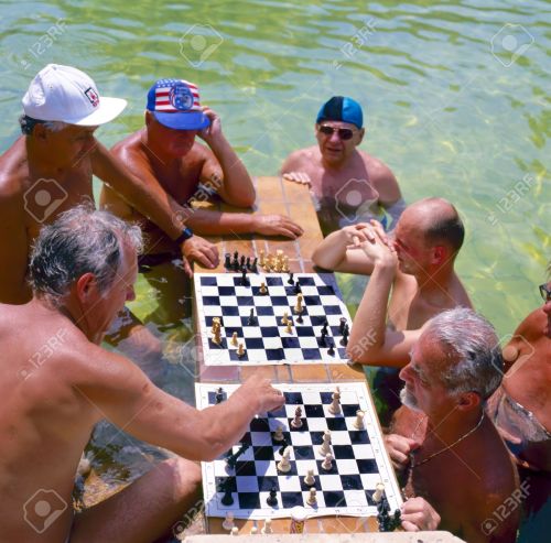 10592756-Men-playing-chess-in-the-Szechenyi-thermal-baths-spa-and-swimming-pool-in-Budapest-Hungary-Focused-a-Stock-Photo